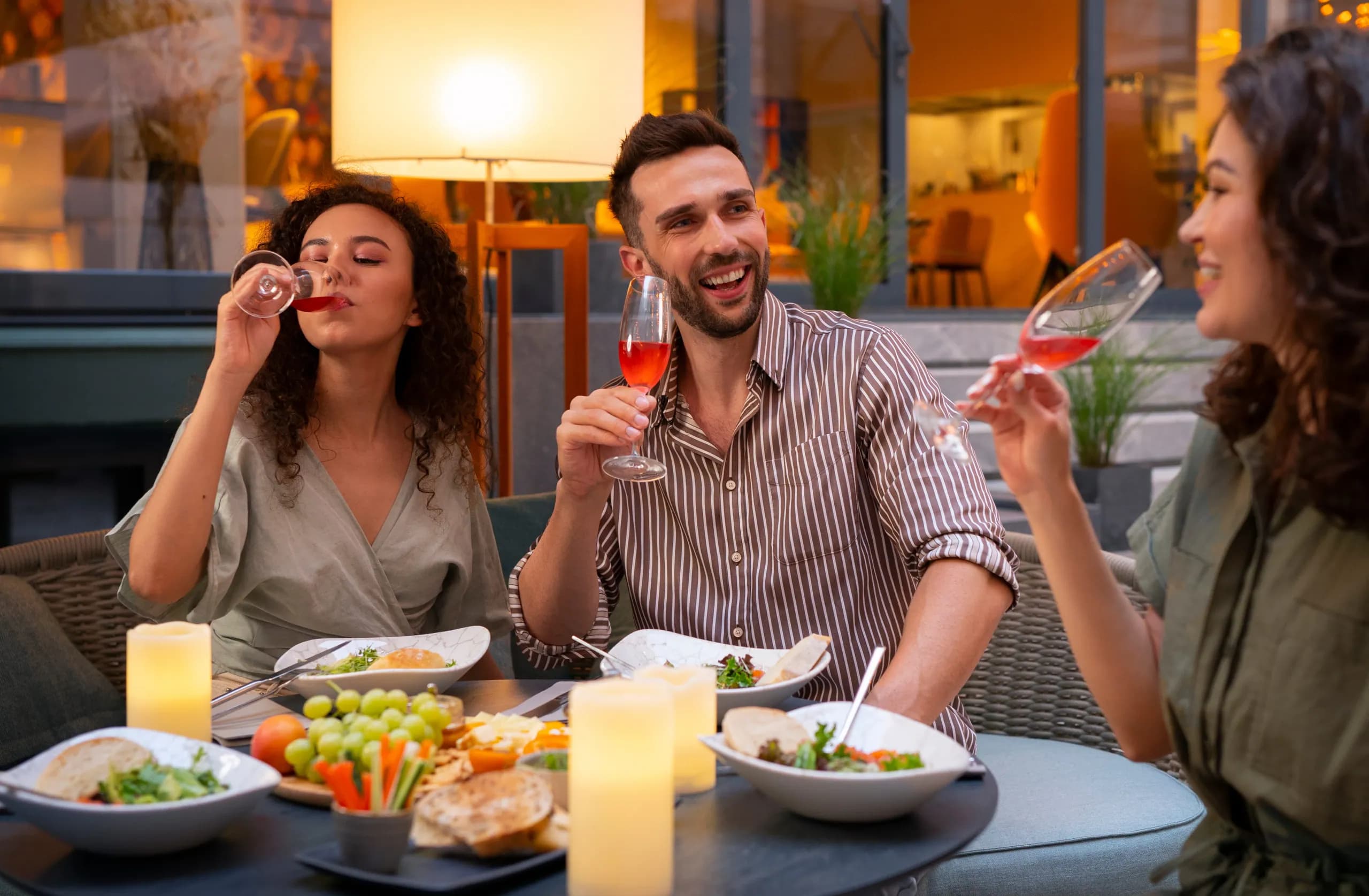 A group of friends raising their glasses around a dinner table